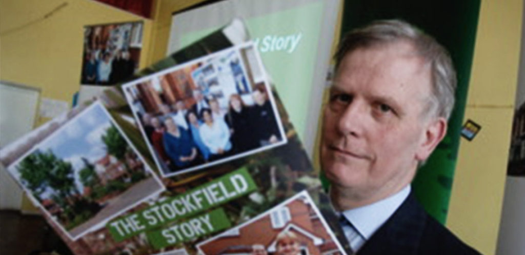 Man reading the Stockfield Story brochure